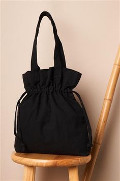 a black bag sitting on top of a wooden chair