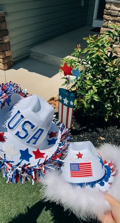 a patriotic hat with the number usa on it is sitting in front of a house