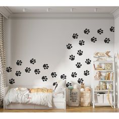 a bedroom with white walls and black paw prints on the wall