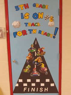 a door decorated with mario kart and other cartoon characters on the road to finish