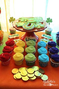 cupcakes, cookies and candy are arranged on a table