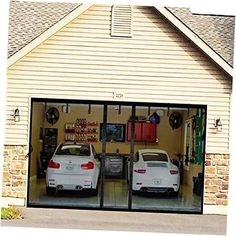 two white cars parked in front of a garage