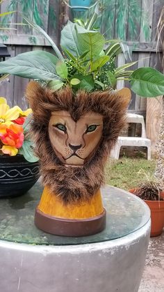 a lion head planter sitting on top of a table