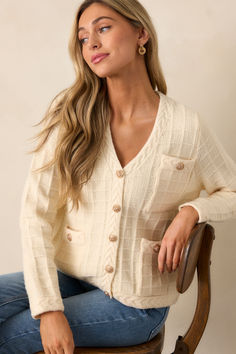 Stay ahead of the fashion game with our Quiet Days Ivory Cable Knit Cardigan. This stylish and versatile sweater is the perfect addition to your wardrobe, allowing you to effortlessly elevate any outfit. With its soft and cozy fabric, you'll feel confident and comfortable all day long. Don't miss out on this must-have piece! This ivory cardigan features a v-neckline, a functional button front with gold buttons, a cable knit grid design, functional pockets, braided knit hems, and long sleeves. Elegant Beige Soft Knit Cardigan, Chic Soft Texture Cardigan For Loungewear, Elegant Beige Knit Outerwear, Cream Knit V-neck Outerwear, Elegant Soft Knit Sweater Coat For Spring, Chic Knit Cardigan With Soft Texture, Chic V-neck Sweater Coat In Soft Knit, Chic V-neck Soft Knit Sweater Coat, Chic Soft Texture Long Sleeve Cardigan