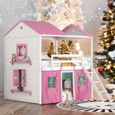 a pink and white doll house next to a christmas tree