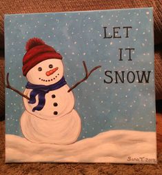 a painting of a snowman with the words let it snow painted on it's side