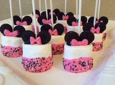 minnie mouse cupcakes are decorated with pink and black polka dot bowknots