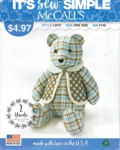 a blue and white teddy bear with polka dots on it's chest, sitting in front of the us $ 4 99 price label