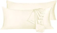 two white pillows with ruffles on them