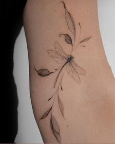 a woman's arm with a flower tattoo on the left side of her body