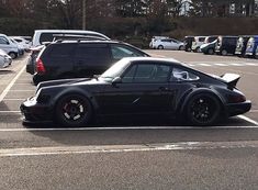 a black sports car parked in a parking lot