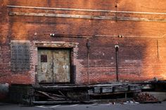 an old brick building with a wooden door