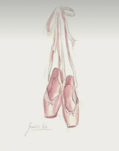 a pair of ballet shoes hanging from a string