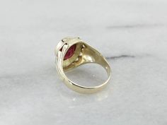 A classic 1930's retro era setting, lightly etched with linear and geometric designs - outfitted with a synthetic ruby stone, reverse-carved with the Shriner's symbol, this men's ring is one handsome piece! The Ancient Arabic Order of the Nobles of the Mystic Shrine, also commonly known as Shriners, is a men's fraternity organization associated with the Free Masons. The Shriner's symbol is inlaid into the ruby red stone with stunning saturated yellow gold! Metal: 14K Yellow Gold Gem: Red Glass G Antique Ruby Signet Ring For Formal Occasions, Vintage Ruby Rings With Polished Finish, Classic Ruby Signet Ring, Classic Ruby Ring With Polished Finish For Collectors, Heirloom Ruby Signet Ring With Polished Finish, Vintage Ruby Signet Ring Hallmarked, Vintage Hallmarked Ruby Signet Ring, Vintage 14k Gold Ruby Ring With Polished Finish, Retro Formal Rings With Polished Finish