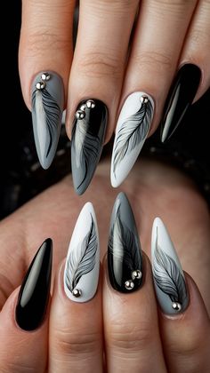 Discover the chic allure of this stunning nail design featuring long, stiletto-shaped nails adorned with beautifully hand-painted feather patterns. The combination of glossy black and white, alongside a soft gray base, creates a striking contrast. Accented with delicate metallic embellishments, these nails are perfect for making a bold fashion statement!
#nailsdesign #nailsinspo #decembernails #winternails #acrylicnails