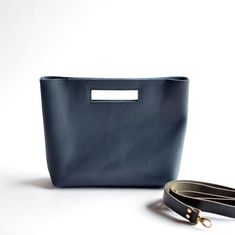 "Say hello to your new favorite handbag! She's a charming handbag with the option of including a removable black leather crossbody strap! With clean lines & modern look, the unique cutout handle adds a bit of fun.  Navy Blue Leather Black Leather Detachable Strap + Attached D Rings (optional) Brass Hardware ... * Fast & FREE USPS Shipping * Open interior pocket * Hidden magnetic closures * Measurements: 13\" wide across top, 11\" wide across bottom, 9.75\" high, 3\" deep * Optional: removable + adjustable crossbody strap with attached D rings * Made to order in Bellingham, Washington Questions? Contact me before placing your order! OPTIONAL ADD-ON Boho Adjustable Straps" Leather Bags For Women, Soft Leather Bag, Women Crossbody Bag, Favorite Handbags, Crossbody Bag Women, D Rings, Leather Bag Women, Navy Leather, Leather Bags