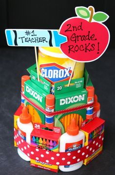 a stack of school supplies sitting on top of a black table next to a sign that says 2nd grade rocks