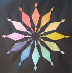 a black background with multicolored paper and an abstract design on the bottom half