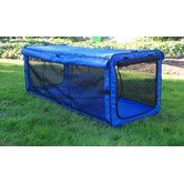 a blue dog kennel in the grass