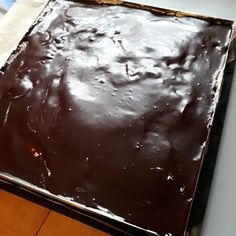 a square chocolate cake sitting on top of a table