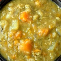 a close up of a bowl of soup with carrots