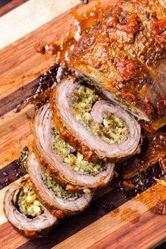 sliced meatloaf on a cutting board with sauce