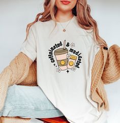 a woman sitting on a stool wearing a white shirt with the words starbucks and coffee printed on it