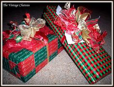 two presents wrapped in red and green wrapping paper with bows on them sitting next to each other