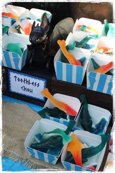 toothbrushes displayed in plastic containers for sale at an outdoor market stall on a table