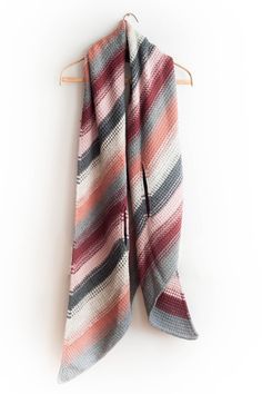 a striped scarf hanging on a clothes hanger