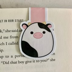 a bookmark with a cow on it's face