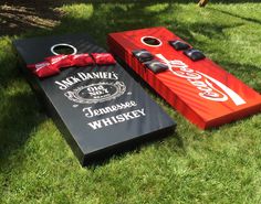 two cornhole game boards sitting in the grass