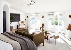 a living room filled with furniture and lots of windows