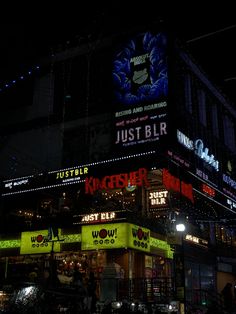 a building with neon signs on it at night