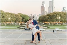 a man and woman kissing in front of a cityscape