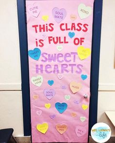 a bulletin board with hearts on it in front of a door that says, this class is full of sweet hearts