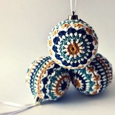 crocheted ornaments are hanging on a string