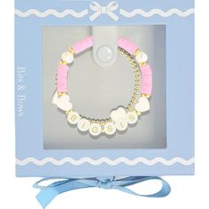 a pink and white bracelet in a box with a blue ribbon on the bottom that says first order days