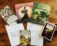 several children's books on a wooden table