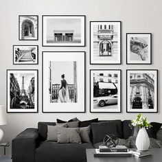 a black and white living room with pictures on the wall