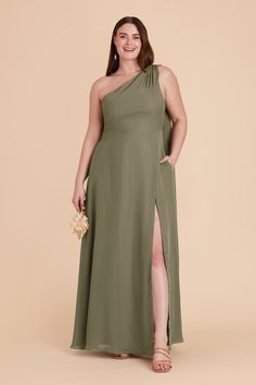 a woman in a green one shoulder dress