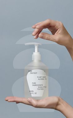 two hands holding a bottle of hand sanitizer against a gray background with the words product on it