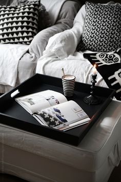 a tray with magazines and a candle on it