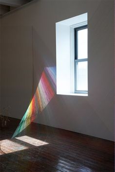 an empty room with sunlight streaming through the window