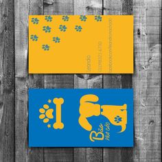 two business cards with paw prints on them, one is blue and the other is yellow