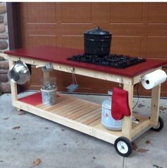 a small cart with pots and pans on it