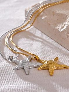 Elegant starfish pendant necklace in gold and silver tones, perfect for adding a touch of coastal charm to any outfit. The intricate design and delicate chain make it an ideal accessory for beach lovers and ocean-inspired fashion. Starfish pendant Lobster claw closure Stainless steel Fall Sweaters For Women, Starfish Pendant, Starfish Necklace, Star Style, Holiday Jewelry, Pin Jewelry, Allergy Free, Ocean Inspiration, Star Pendant