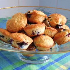 a glass bowl filled with blueberry muffins