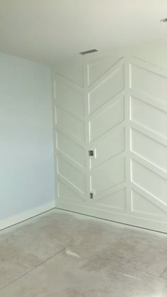 an empty room with white walls and doors