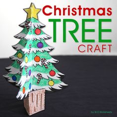 a christmas tree made out of paper on top of a black surface with the words christmas tree craft above it